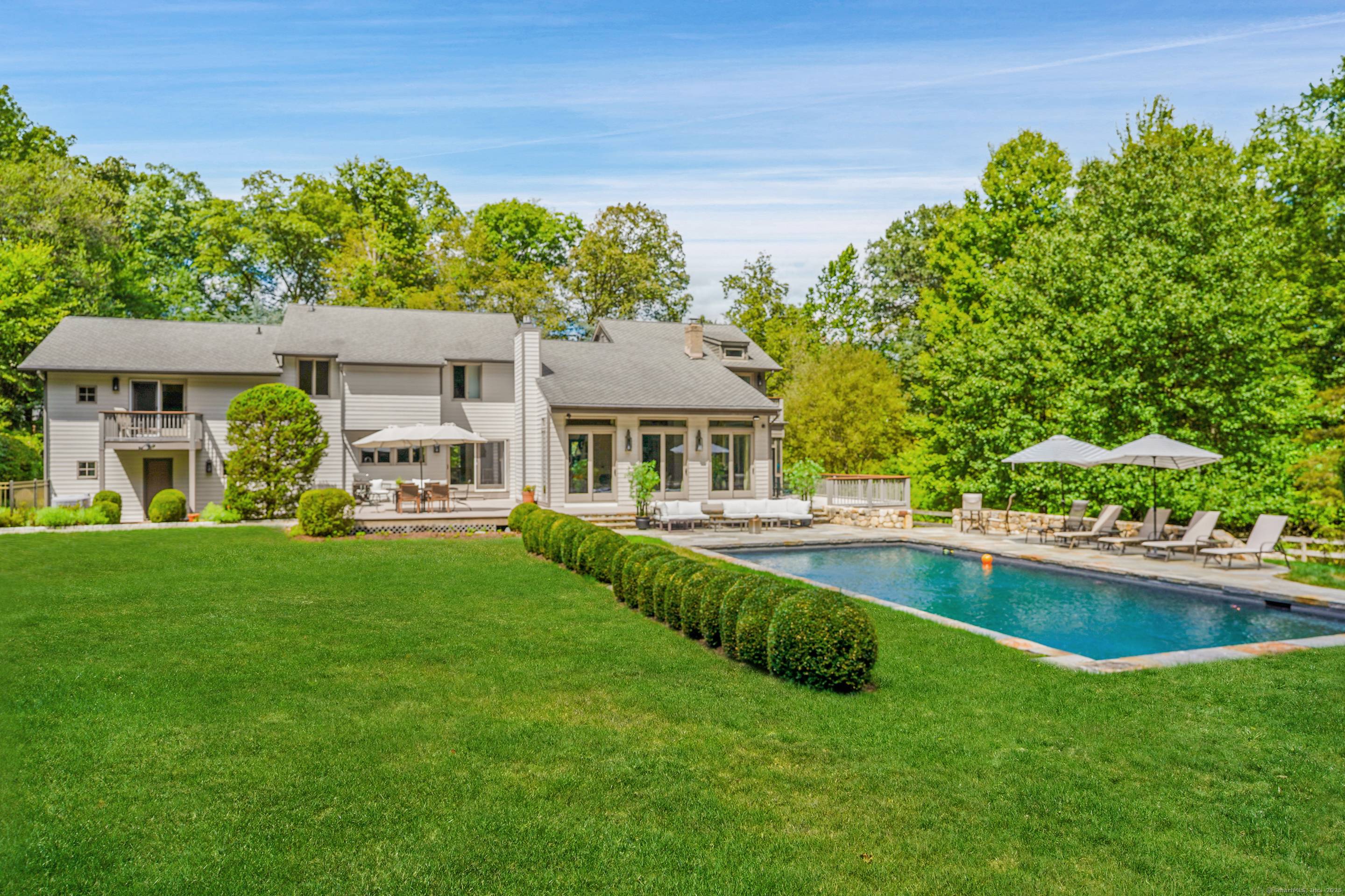 Set on more than two acres of exquisite, park like property in the coveted Red Coat estate section of Westport, this spectacular modern home with a glorious gunite pool offers ...