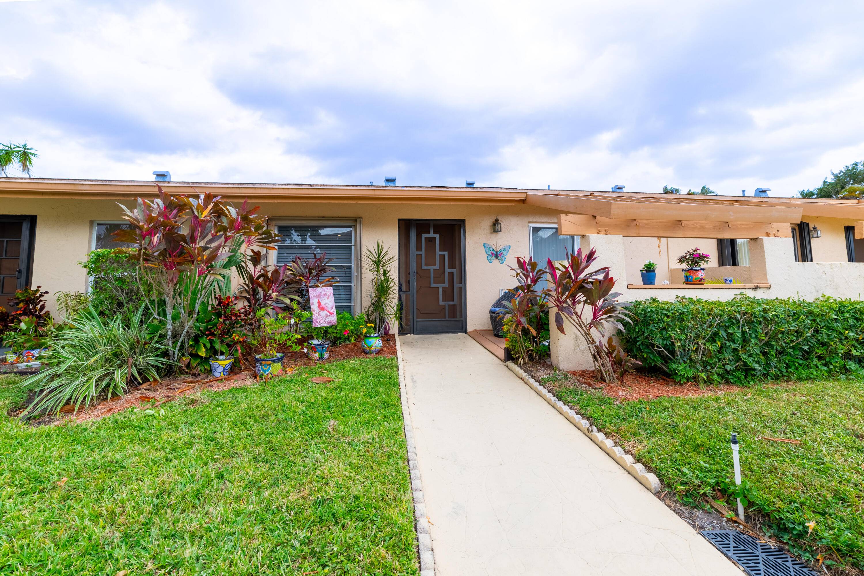 Charming spacious lakeview villa in desirable Palm Greens active adult community.