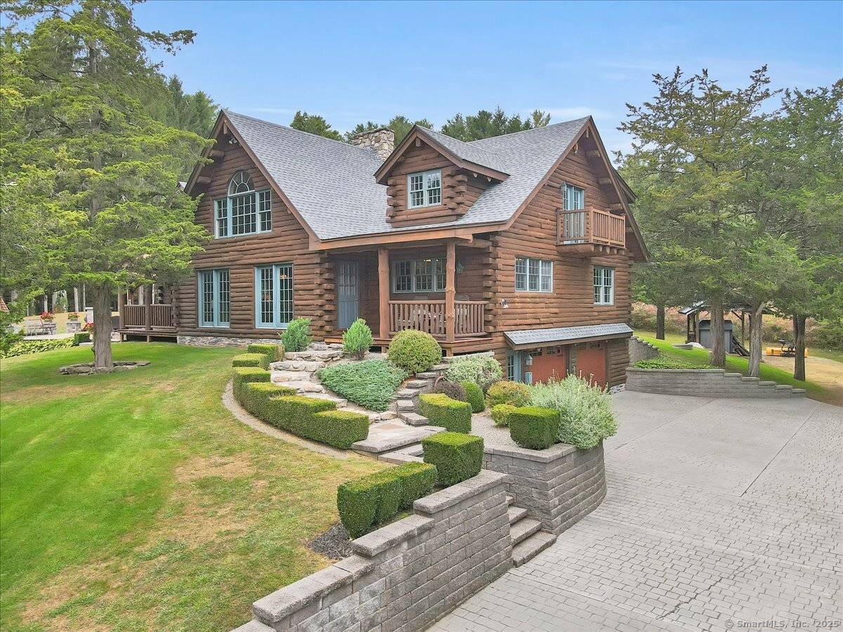 Rustic Luxury in Connecticut's Quiet Corner Nestled in the hills, this stunning custom log home blends rustic charm with modern comforts.