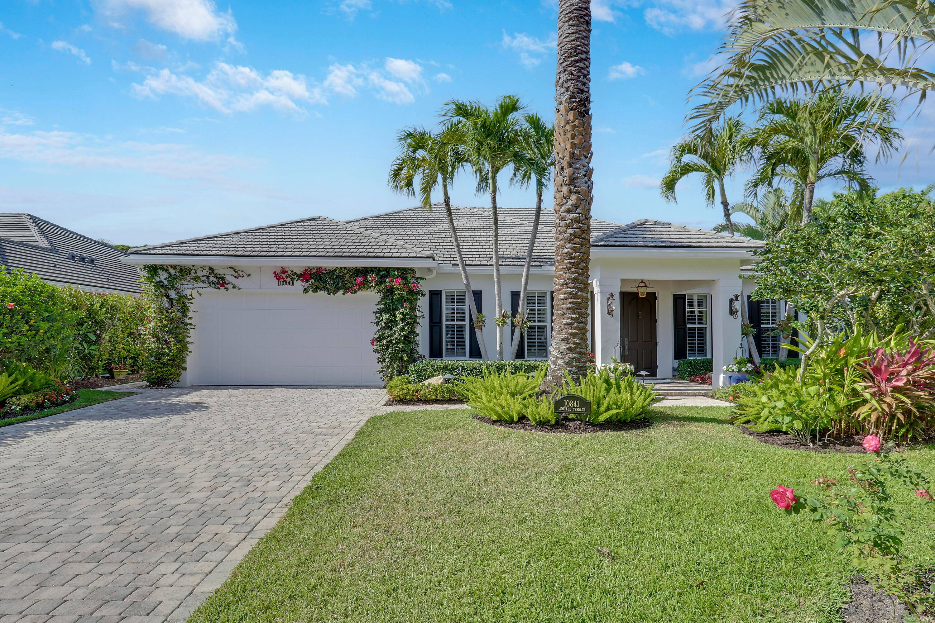 Welcome to 10841 SE Arielle Terrace, an exquisite residence nestled in the exclusive gated enclave of Waters Edge.