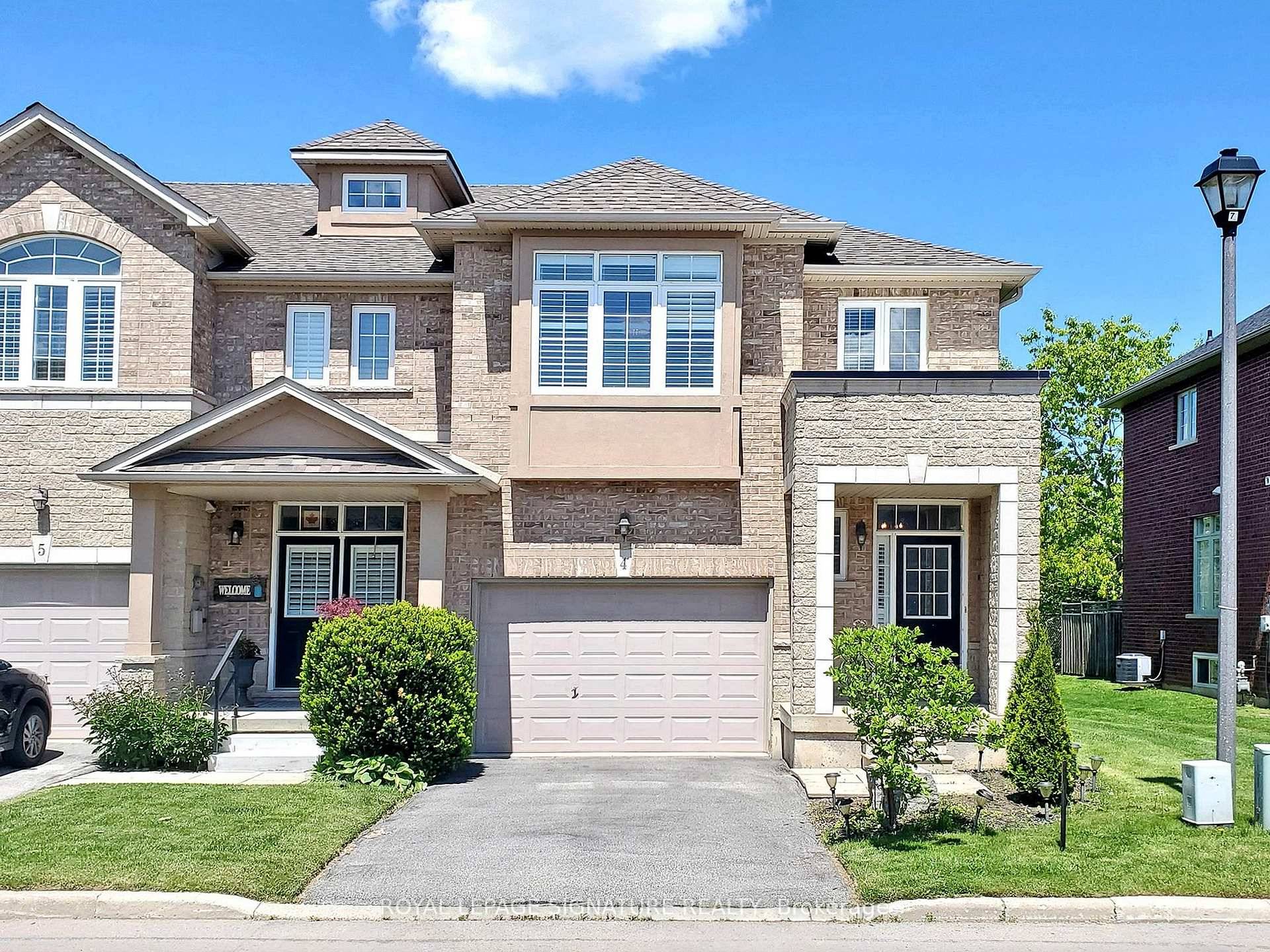 Welcome to 99 Panabaker Drive, a beautifully updated end unit townhome in the heart of Ancaster, backing onto serene green space with a tranquil pond view.