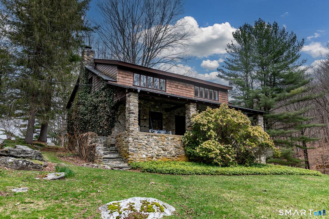 Over forty private wooded acres, a mountain stream, and hiking trails that lead to your own waterfall.