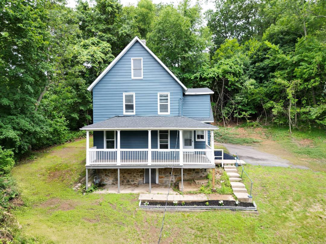 Impressive two family on more than a half acre, perched at the end of a private paved driveway !