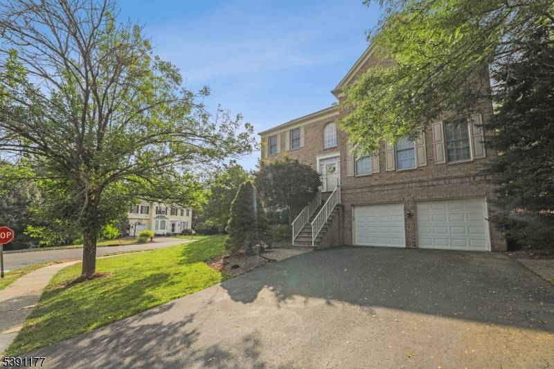 Beautiful four bedroom, three and a half bathroom brick front colonial home situated on a stunning lot with mature landscaping, a spacious patio, and a fenced yard for outdoor enjoyment.