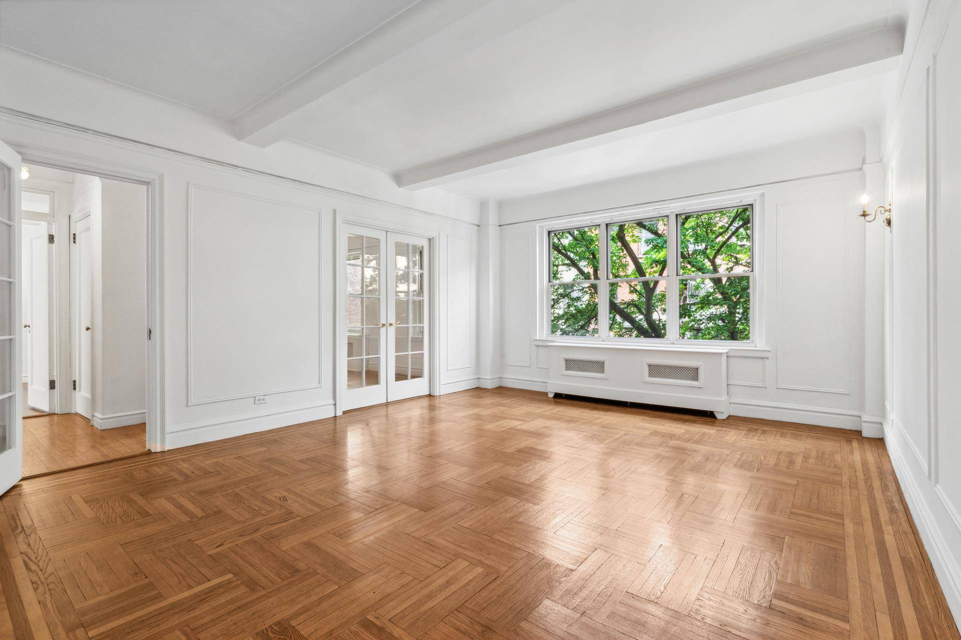 A classic two bedroom, one bath apartment with Upper Westside charm featuring spacious rooms, prewar details such as hardwood floors, beamed ceilings, picture moldings, French doors and transoms.