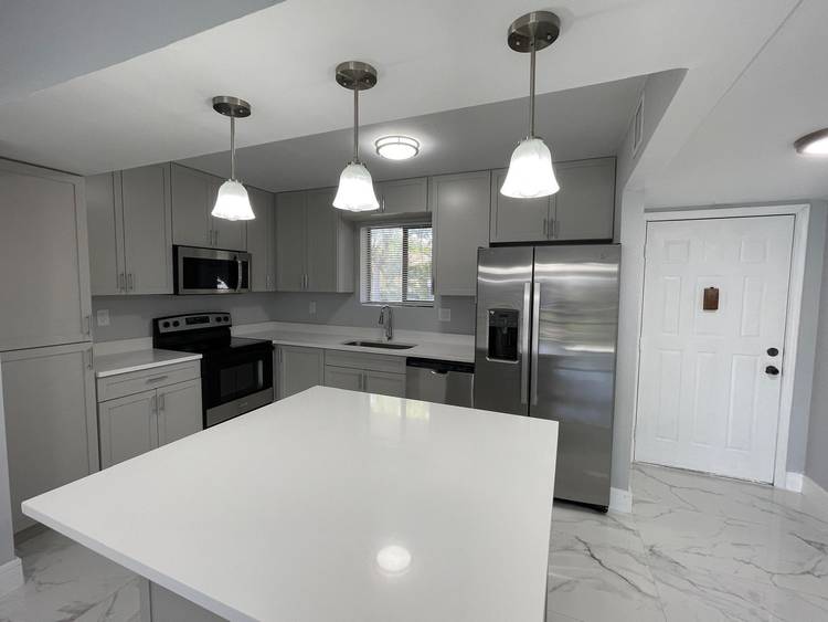 Spacious ground floor 4 bedroom, 2 bath home in a beautiful and quiet neighborhood just west of University Drive.
