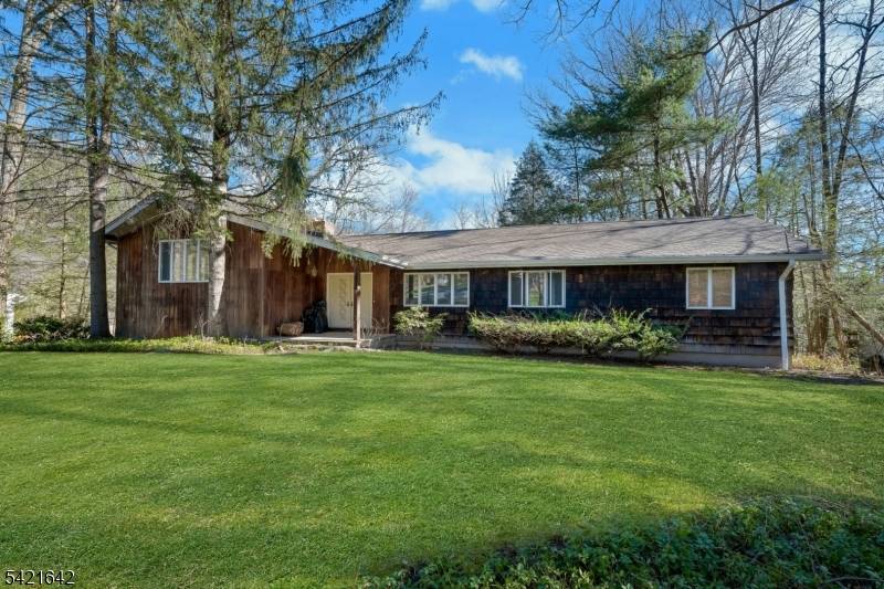 Nestled on a quiet, tree lined street, this stunning mid century modern home offers the perfect blend of timeless design and natural beauty.