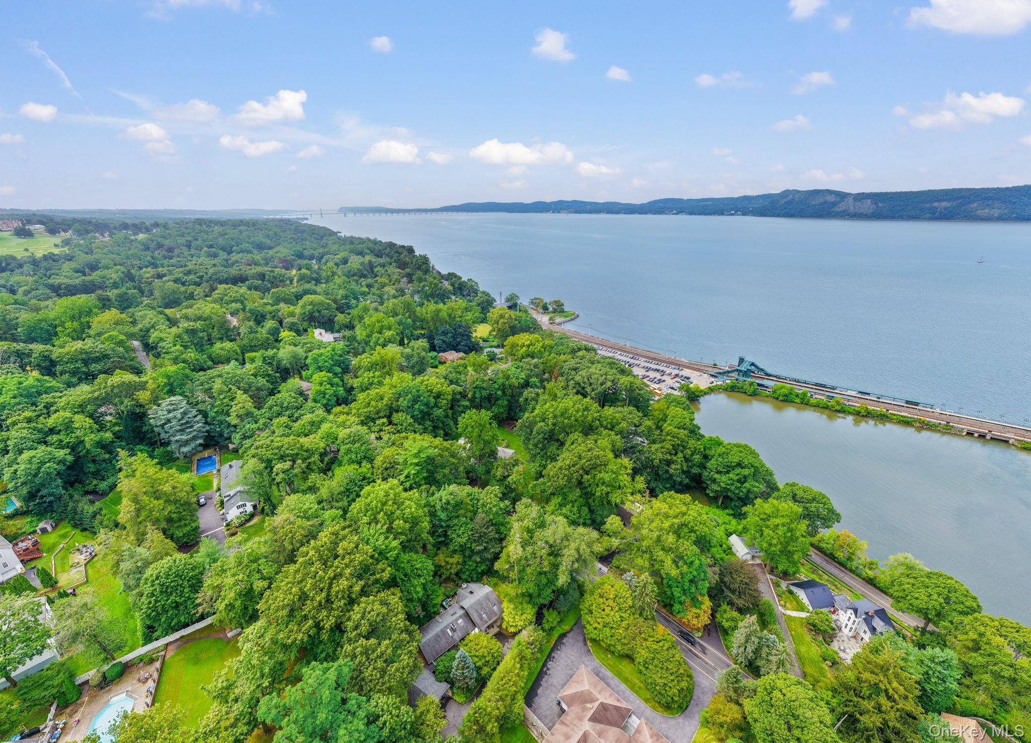 Mid Century Modern elegance meets cottage core charm in this architecturally distinctive cedar home, tucked away in a serene enclave just off the Hudson River.