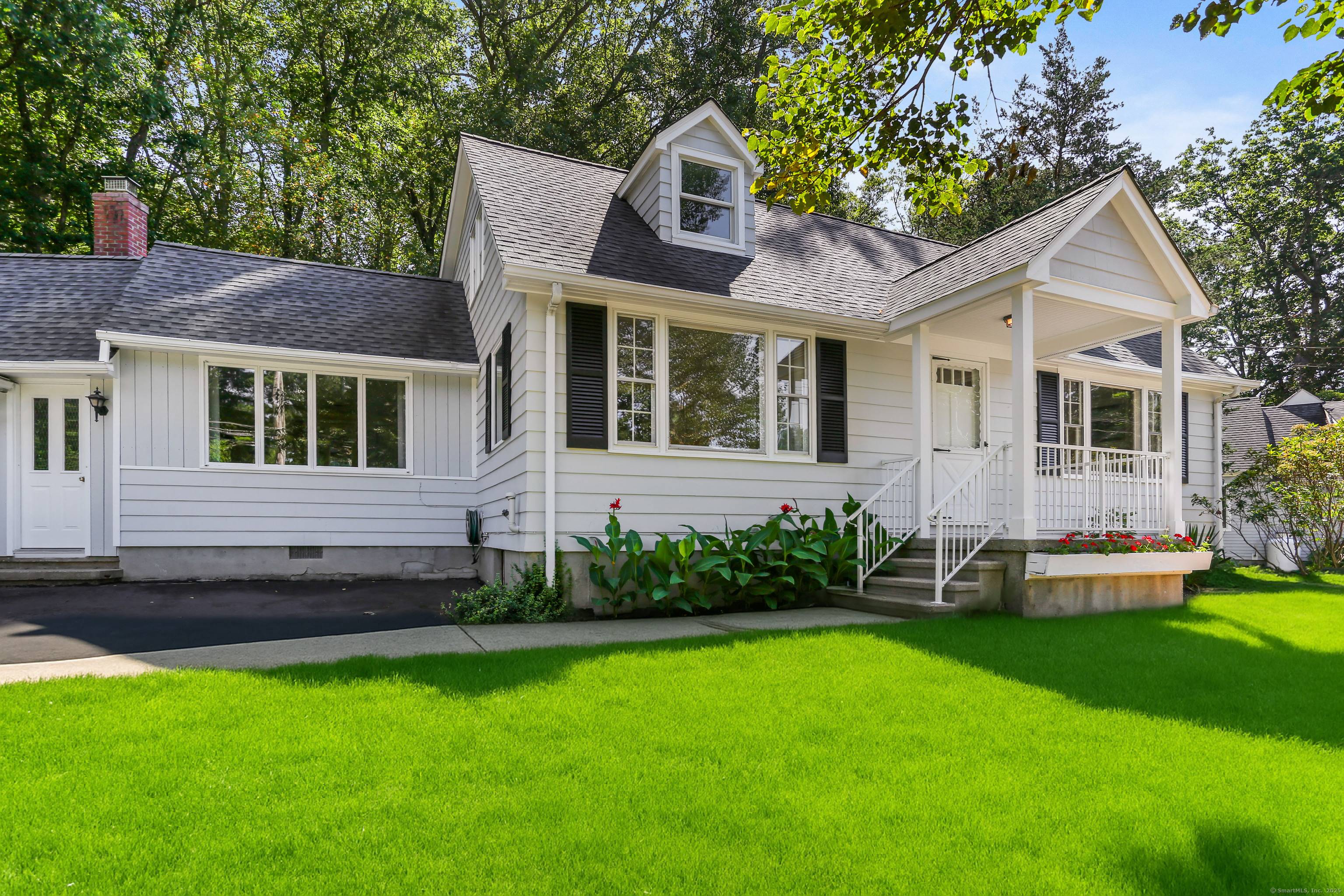 Thoughtfully expanded Cape Cod home in the Lake Hills area, featuring a spacious main level primary suite and 3 additional bedrooms.