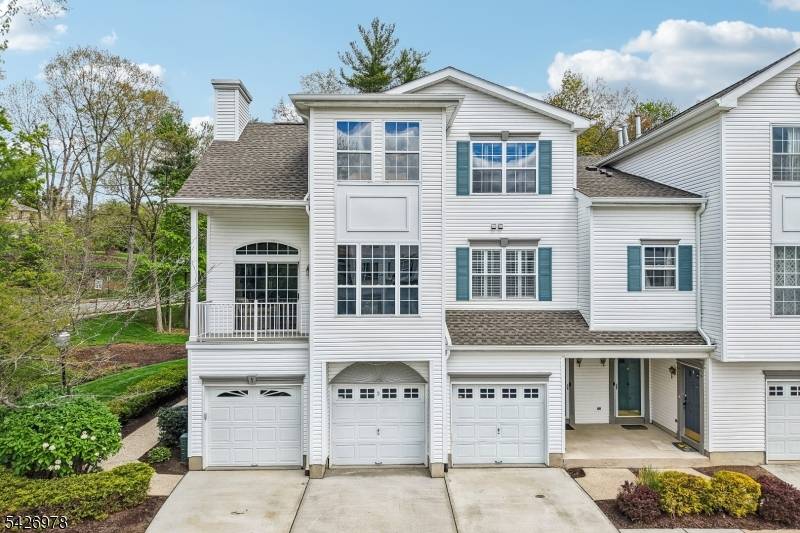 Exquisite, refined end unit nestled among lush trees tranquil green spaces in desirable Rose Arbor community.