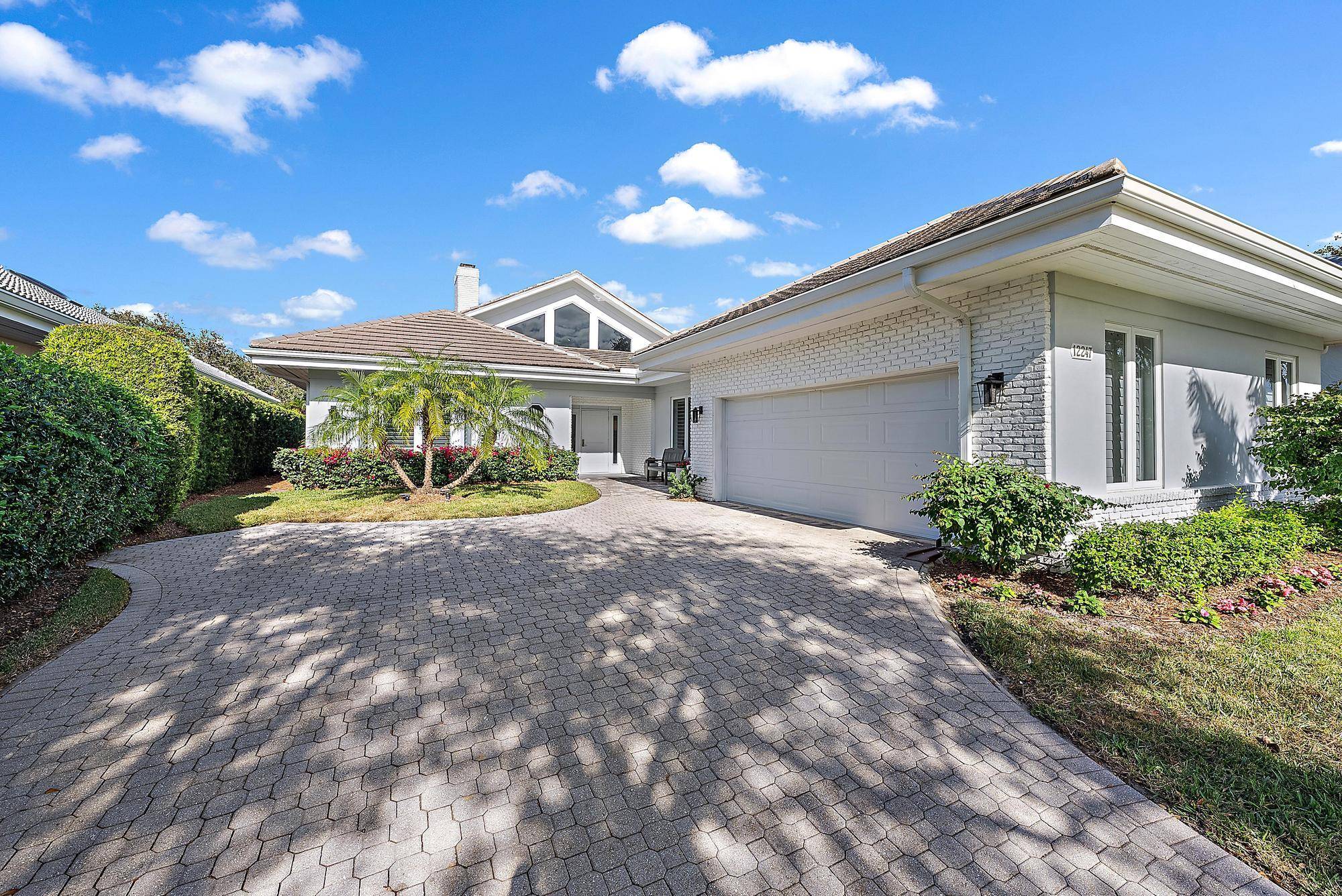Nestled in the prestigious community of Jupiter Hills Village, is a stunning 4 bedroom, 3.