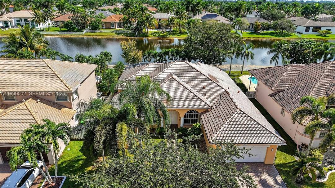 IMMACULATLEY MAINTAINED amp ; RENOVATED 4 Bedroom Office, 3 Bath, LAKEFRONT MONTEREY MODEL POOL HOME in Sought After SERENITY BAY at PEMBROKE FALLS.