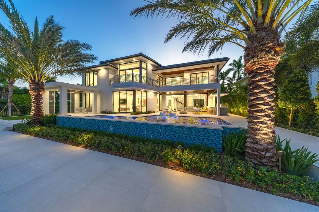 A statement of modern waterfront luxury, 24 Fiesta Way captivates with clean architecture, curated finishes, and 6, 479 SF of refined living.