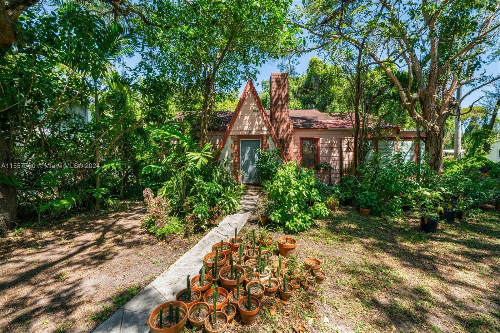Nestled in the serene, leafy embrace of Spring Garden, this historic Tudor style residence offers a haven where tranquility meets the vibrant energy of the Miami River District.