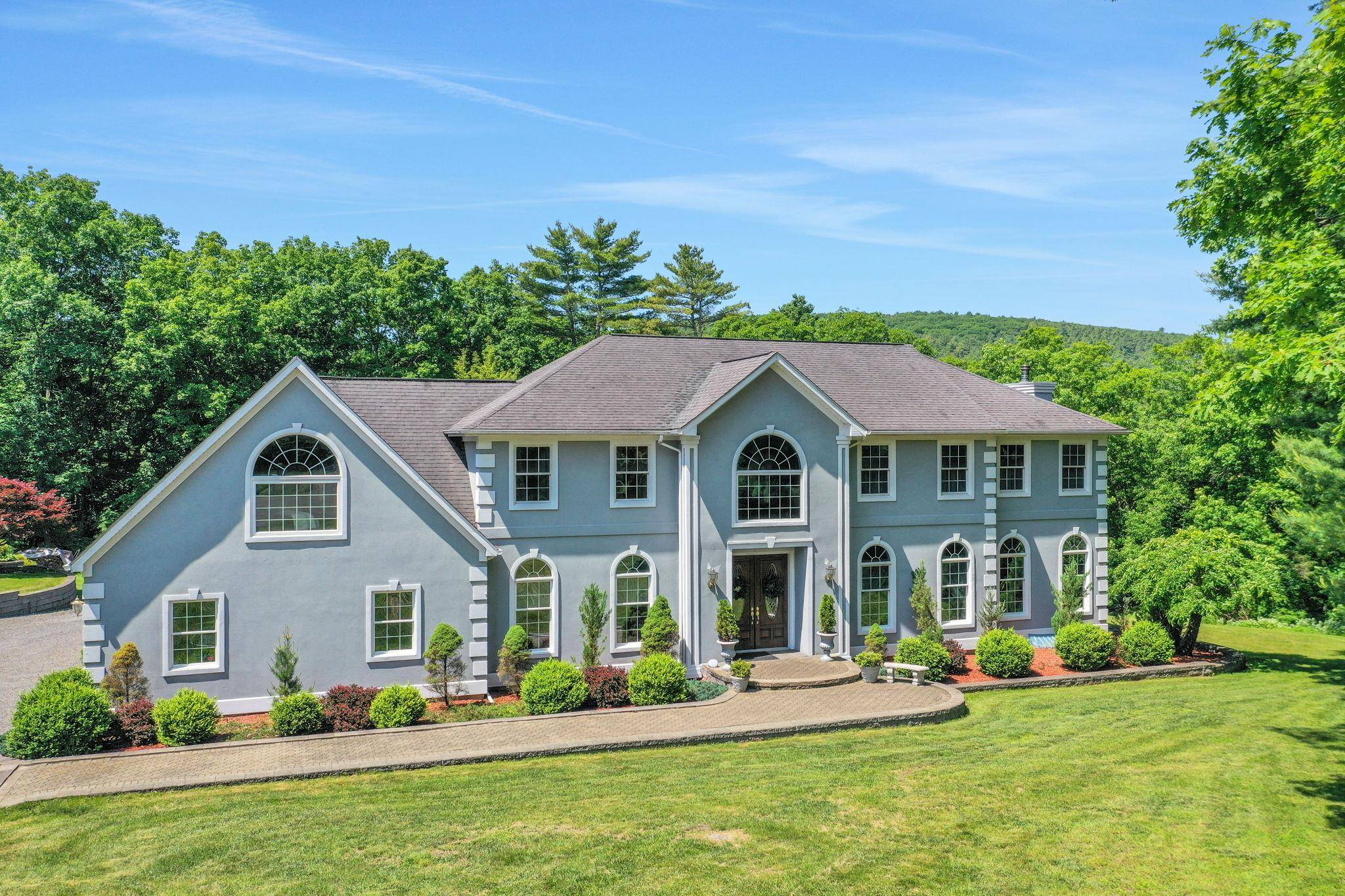 Beautiful custom built Colonial home located in a prestigious neighborhood of higher end luxury homes surrounded by privacy and nature at the end of a cul de sac.