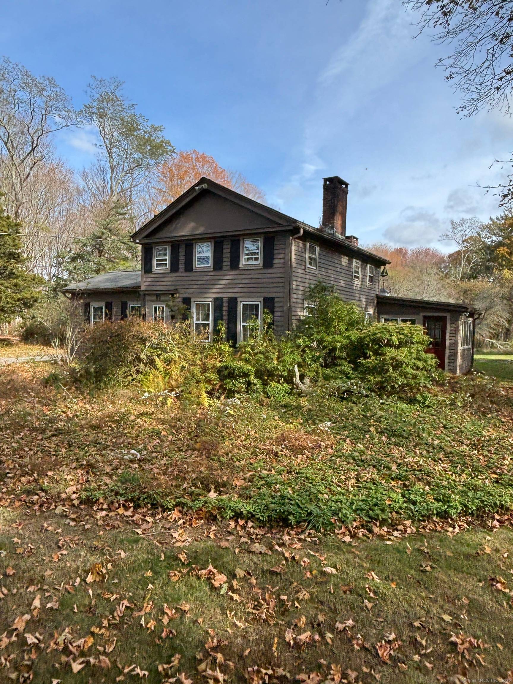 This charming and seemingly sturdy antique home needing updating has substantial value in its 26 acres site.