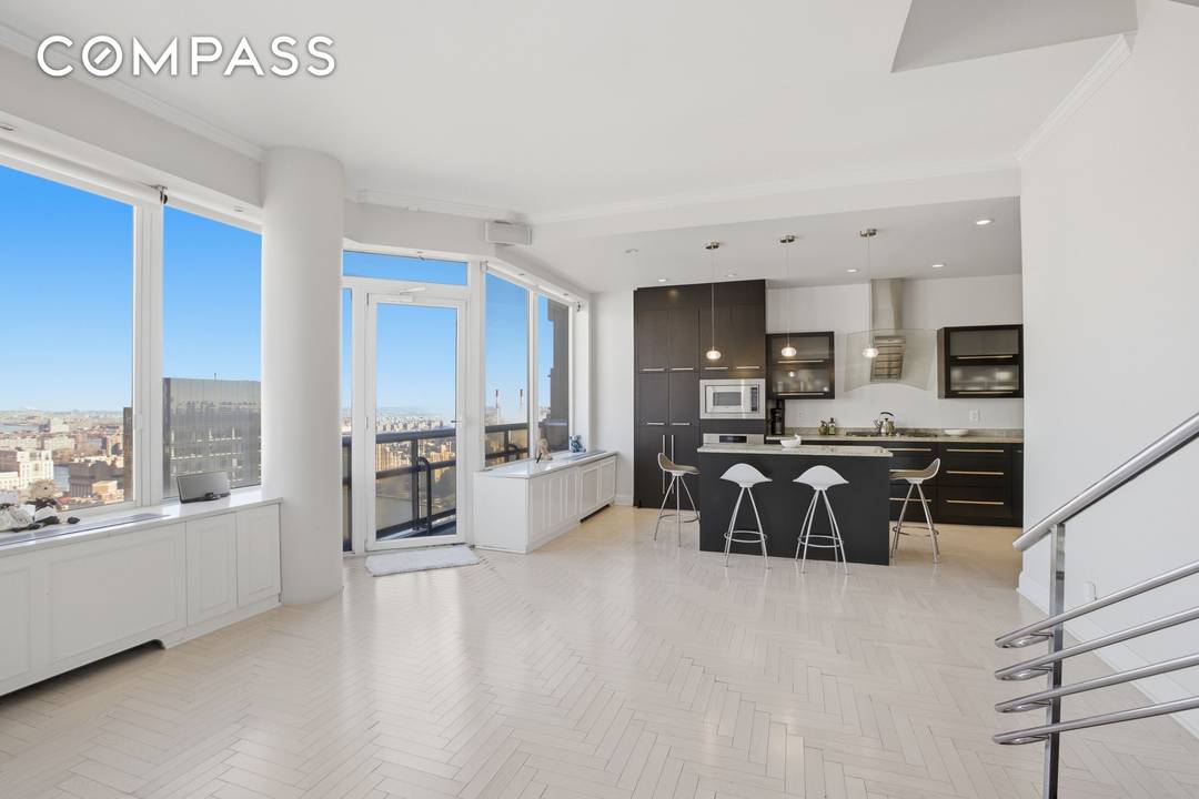 Dramatic 180 degree vistas sweep across the East River and iconic Midtown landmarks, including the Chrysler and Empire State Buildings.