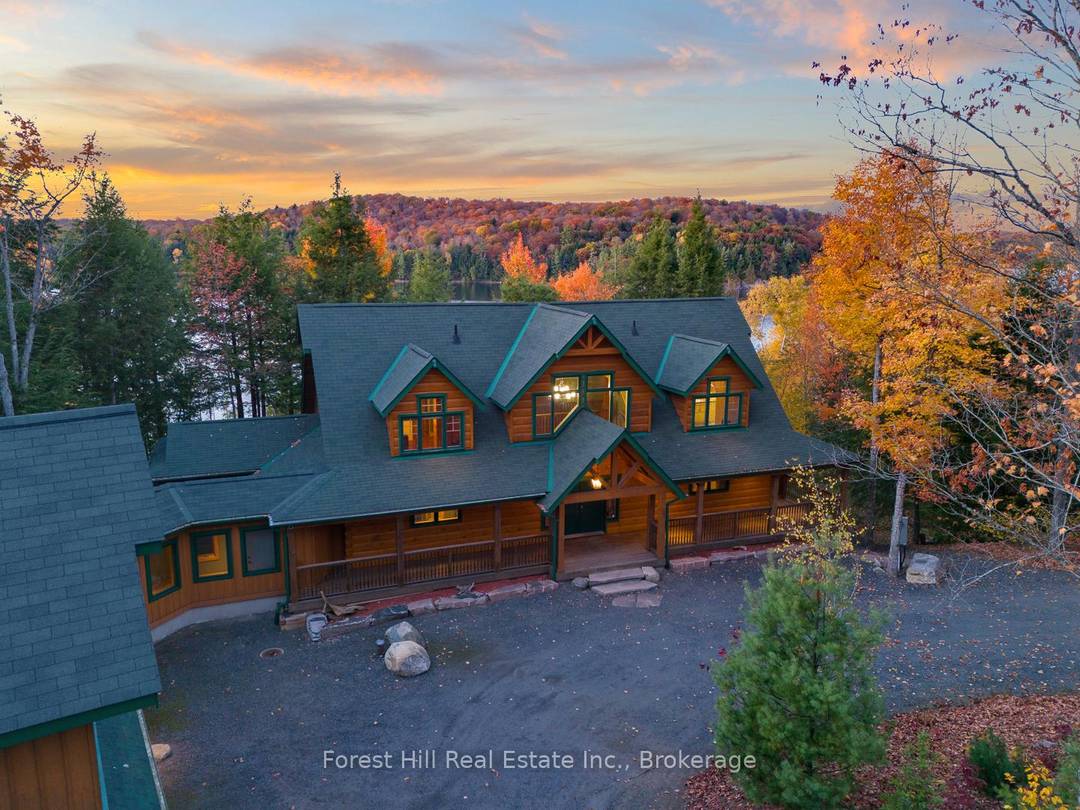 Impressively magnificent custom built log home True North 4, 560 sf ft and over sized, triple car garage with a 2 bedroom guest loft on 8 acres with 500 feet ...