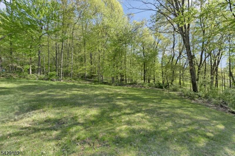 Welcome to 104 Redmont Road, a spacious 4 bedroom, 3 bath ranch set on a stunning 1.