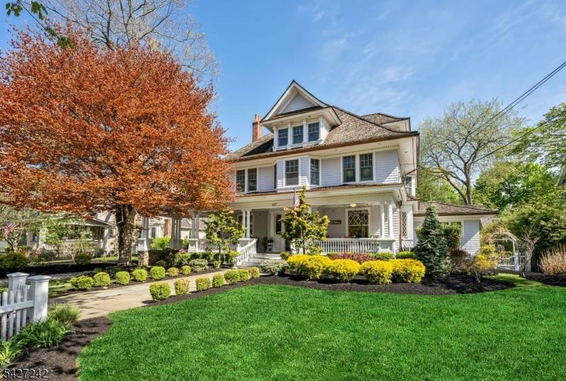 Set on a breathtaking 280 ft landscaped property along prestigious Spring Avenue, this exceptional 5 bedroom, 4.