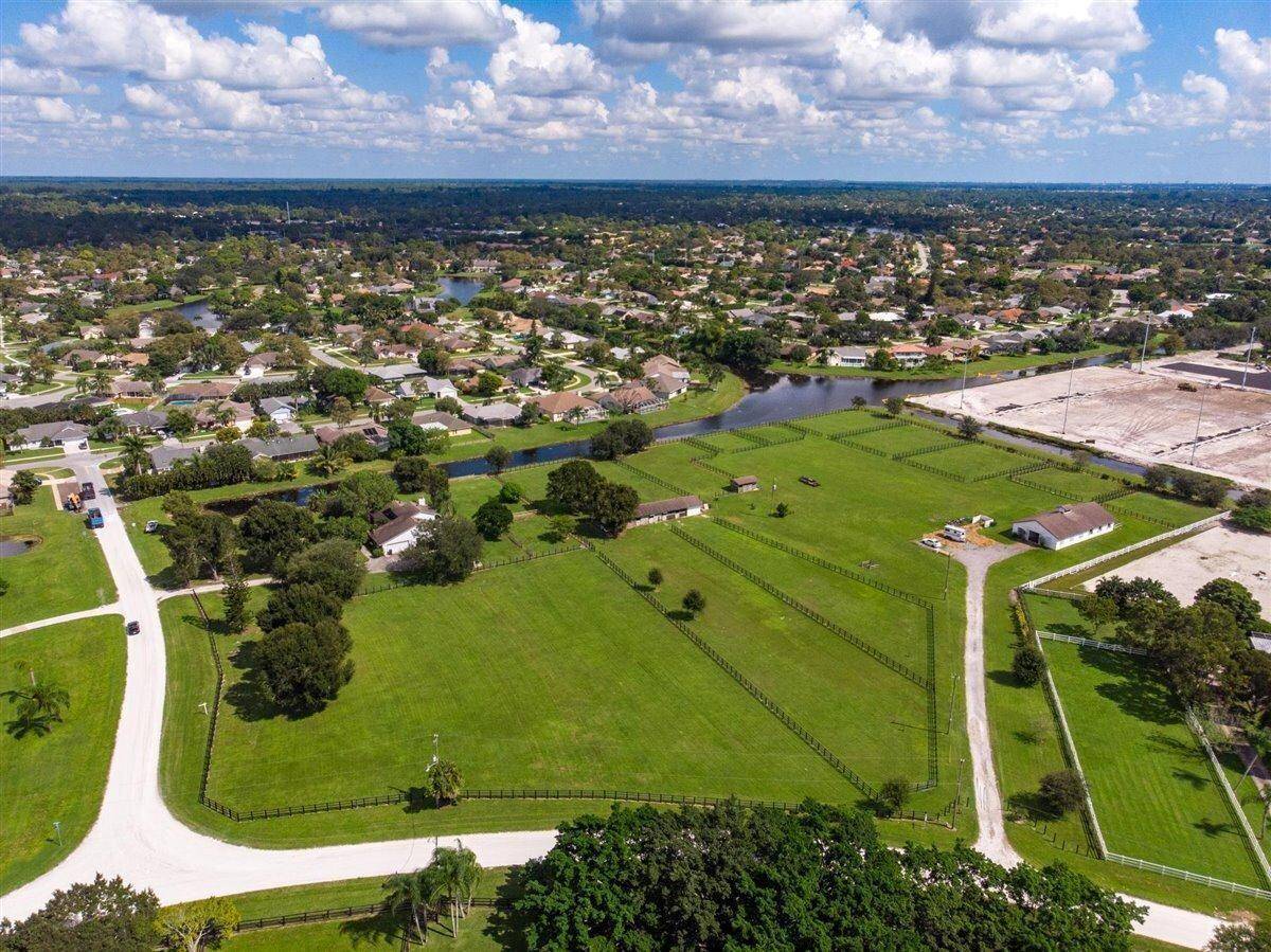 9 stall center isle barn situated on 8 acres with laundry room, tack room, feed room and bathroom.