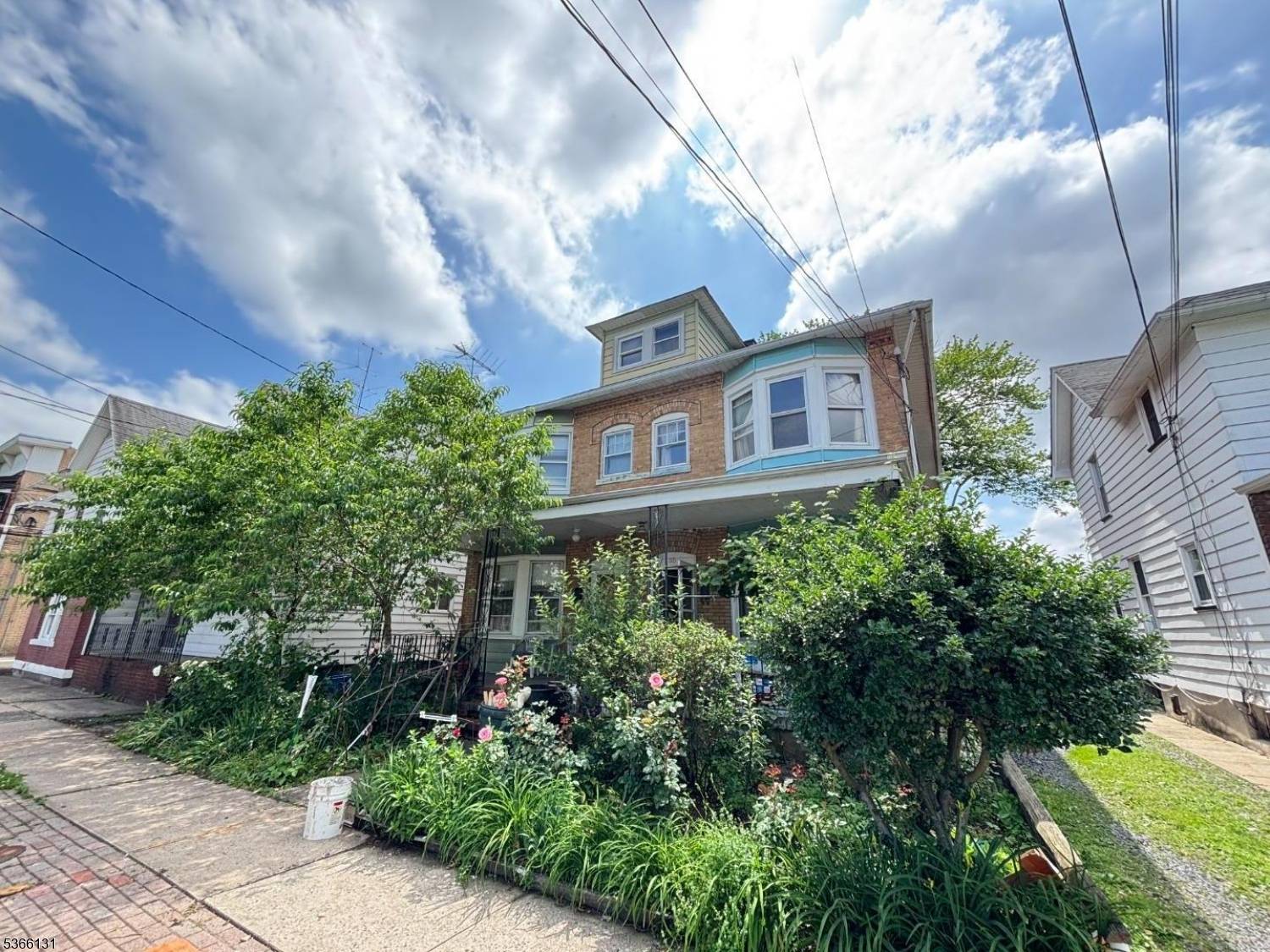 Beautiful brick half duplex with 3 bedrooms, high ceilings on both first and second floors, and open floor plan.