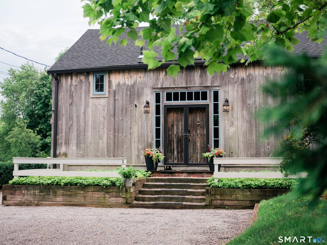 Meticulously maintained and thoughtfully curated, this one of a kind post and beam barn in the Essex Village district offers a rare blend of historic character and modern comfort.
