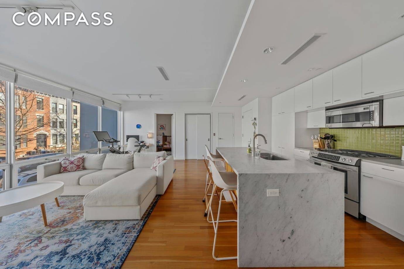 Incredible light pours into this stylish 2 bedroom, 1 bath home featuring floor to ceiling windows and an airy, open concept design.