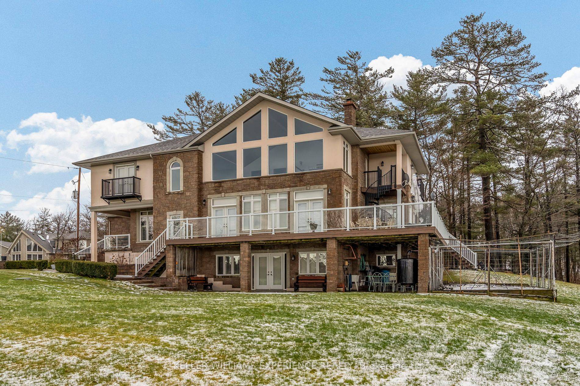 Experience the beauty of Georgian Bay from this stunning two story, five bedroom custom home in Tiny Beaches.
