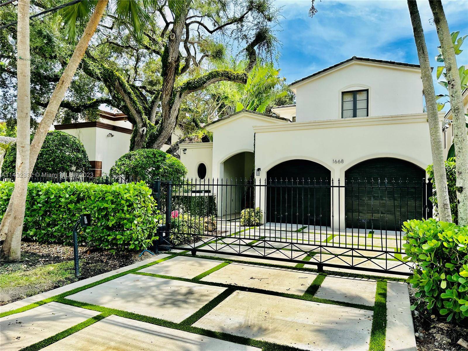 Luxury gated residence on a tree lined street in desirable Coconut Grove.