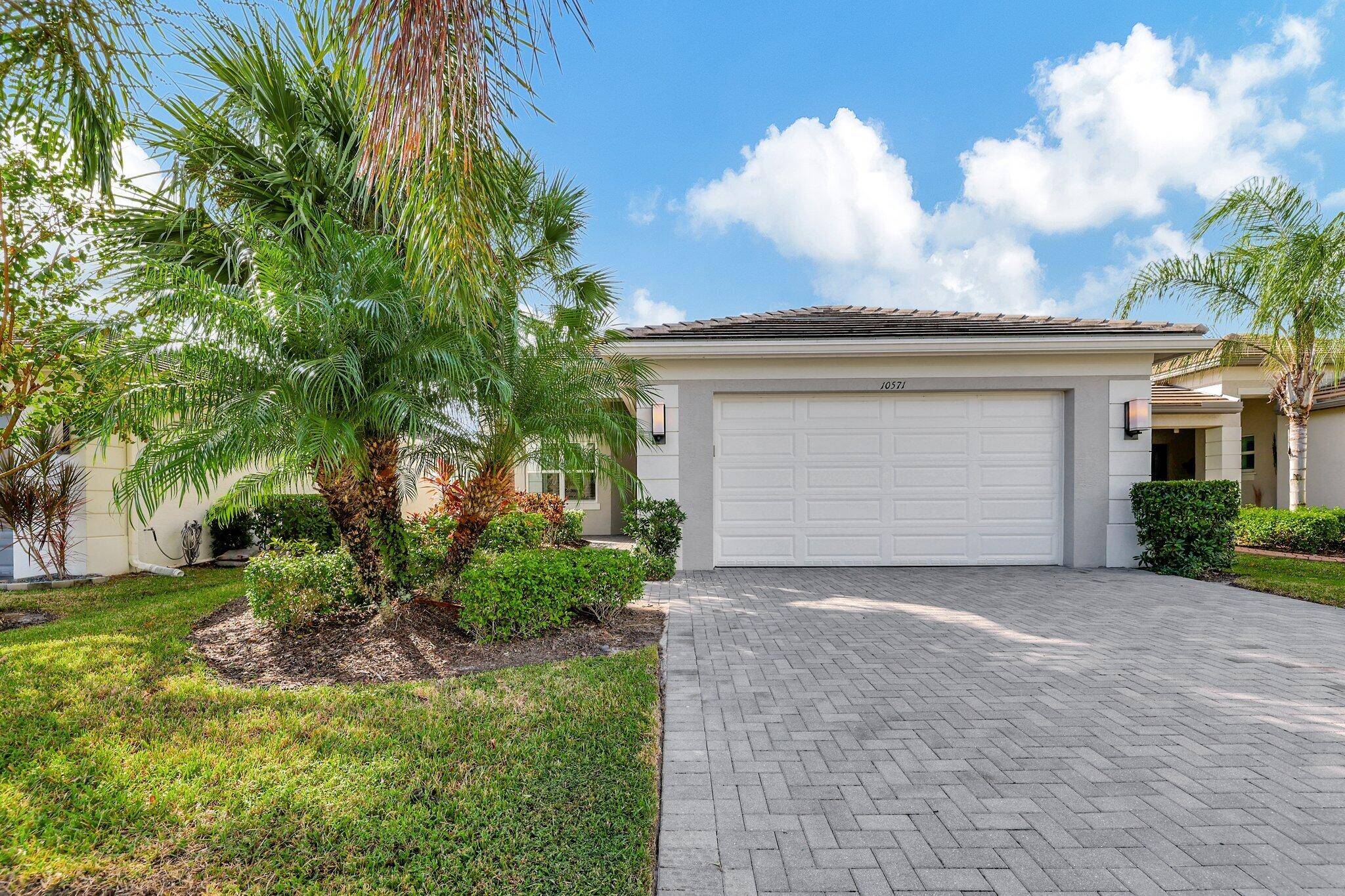Enjoy the magnificent lakefront views in this Tribeca model home located in Valencia Cay at Riverland.