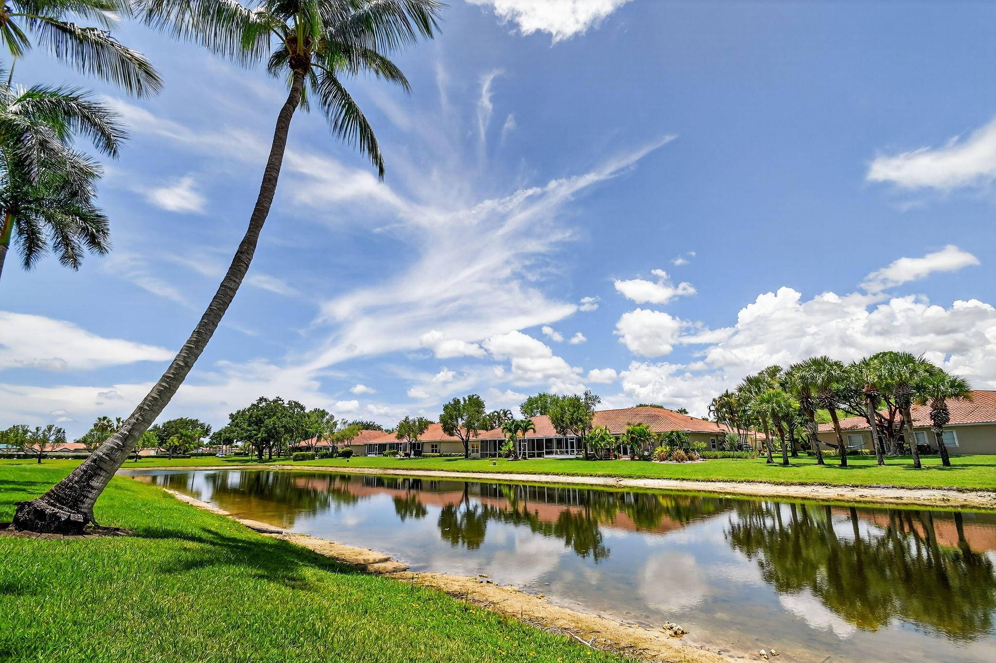 You found your home ! Step into this bright and airy coach home, with views of the water from the glass enclosed Florida room.
