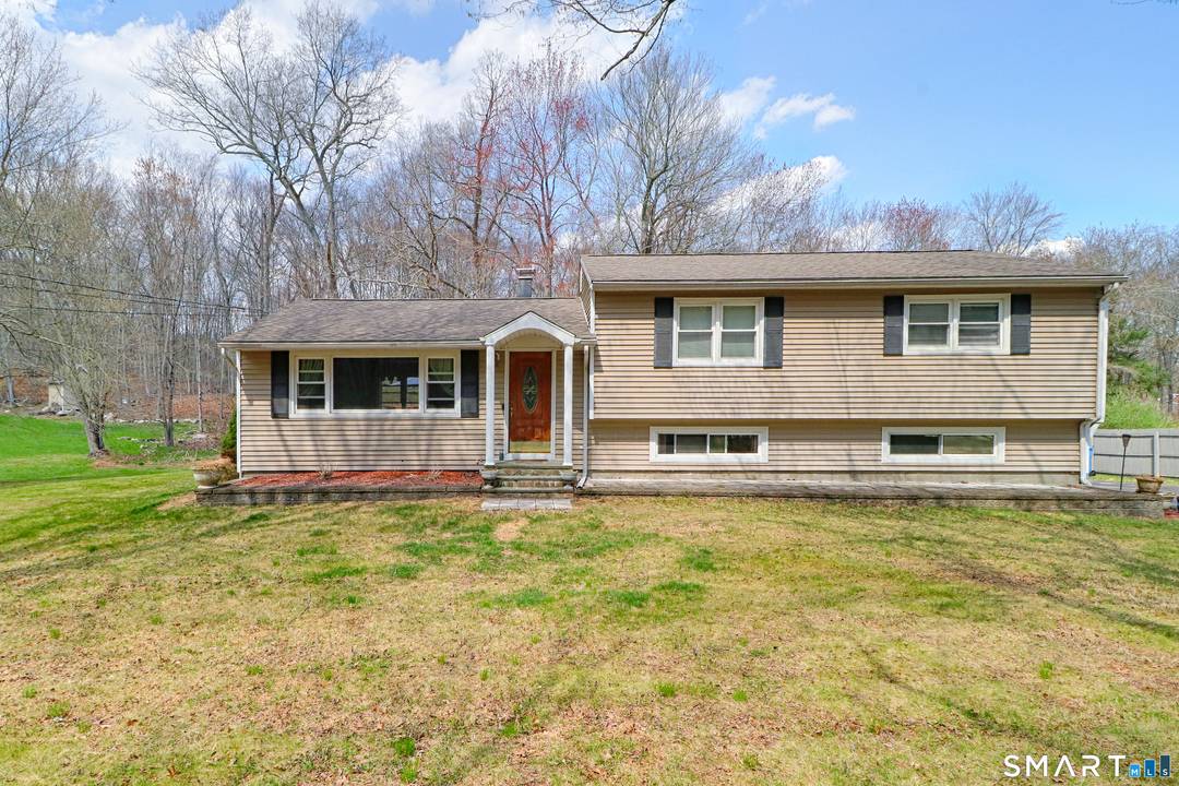 Move in ready 4 bed and 2 full bath split level on a deep, private lot with an open layout, hardwood floors, and partially finished lower level.