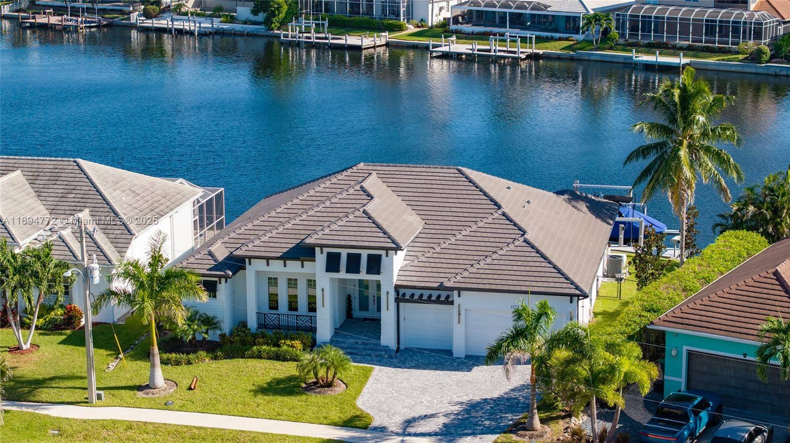 Outstanding wide water view from the minute you walk in in this modern open concept home that features high ceilings and split plan including three bedrooms plus den and three ...