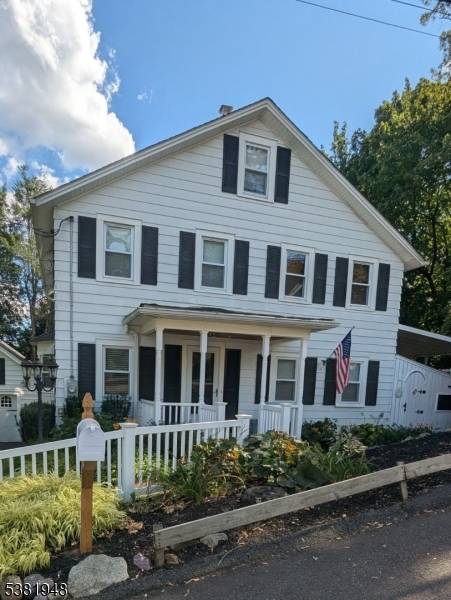 This charming vintage Colonial sits on a beautifully landscaped, park like property and blends classic style with modern updates.