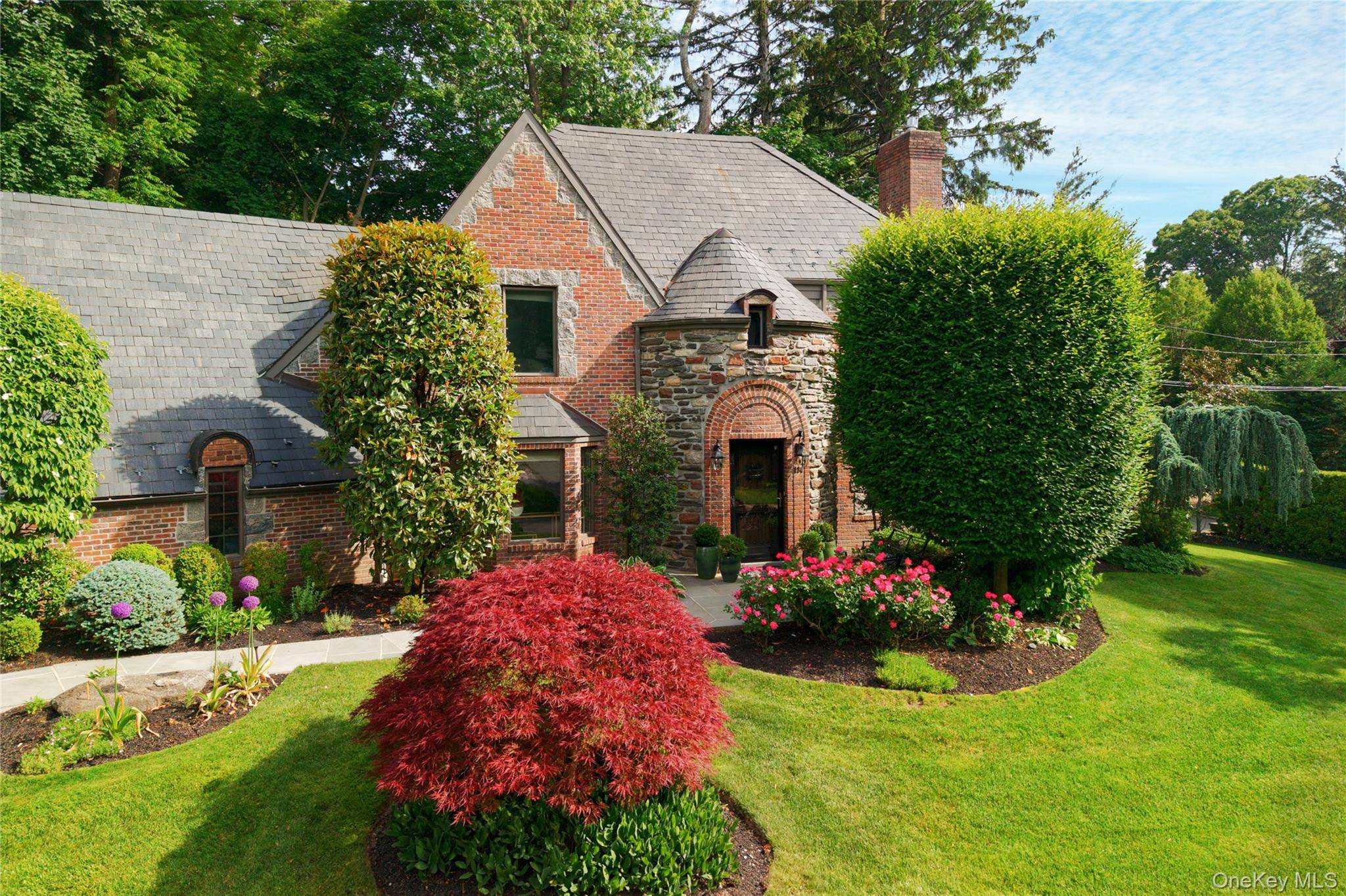 Elegrant and impressive, this stunning, all brick, Tudor style home is located in the heart of South Strathmore, Manhasset.