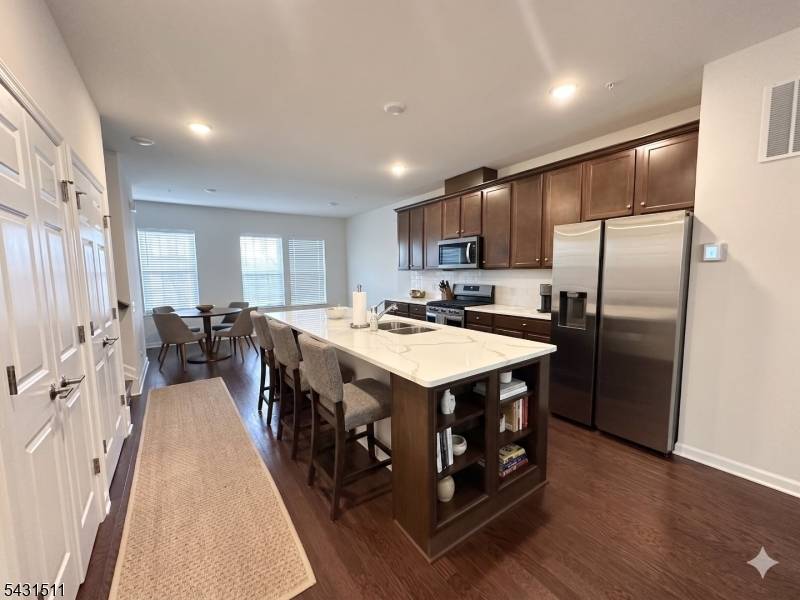 Step into sophisticated living at the prestigious Livingston Square community with this exceptional townhome offering 4 bedrooms, 3.