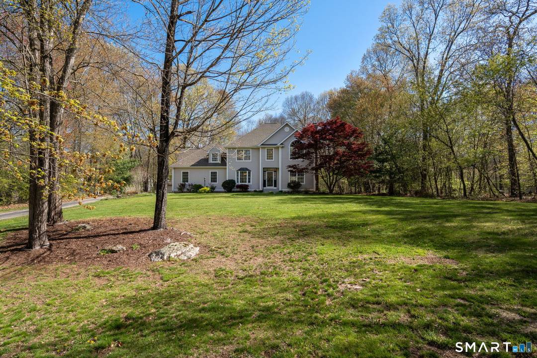 Welcome to this stunning colonial nestled in a lovely Hebron neighborhood at 107 Country Lane.