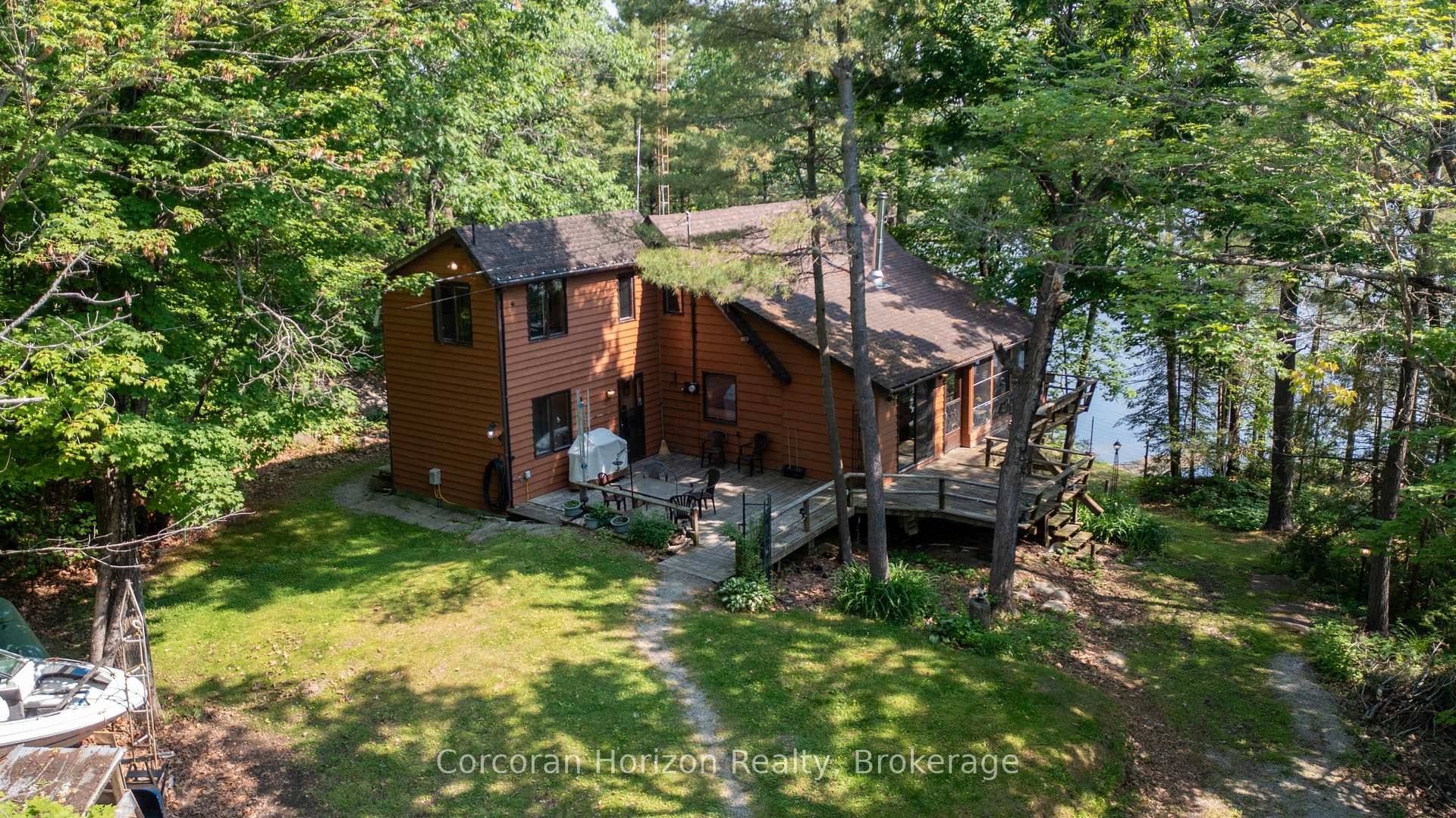 Experience true Muskoka charm at this four season cottage, privately nestled on 1.