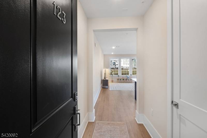 Beautifully designed, newly built townhome at The Hills at Warren, ideally located at the end of the community on a quiet cul de sac with private wooded views.