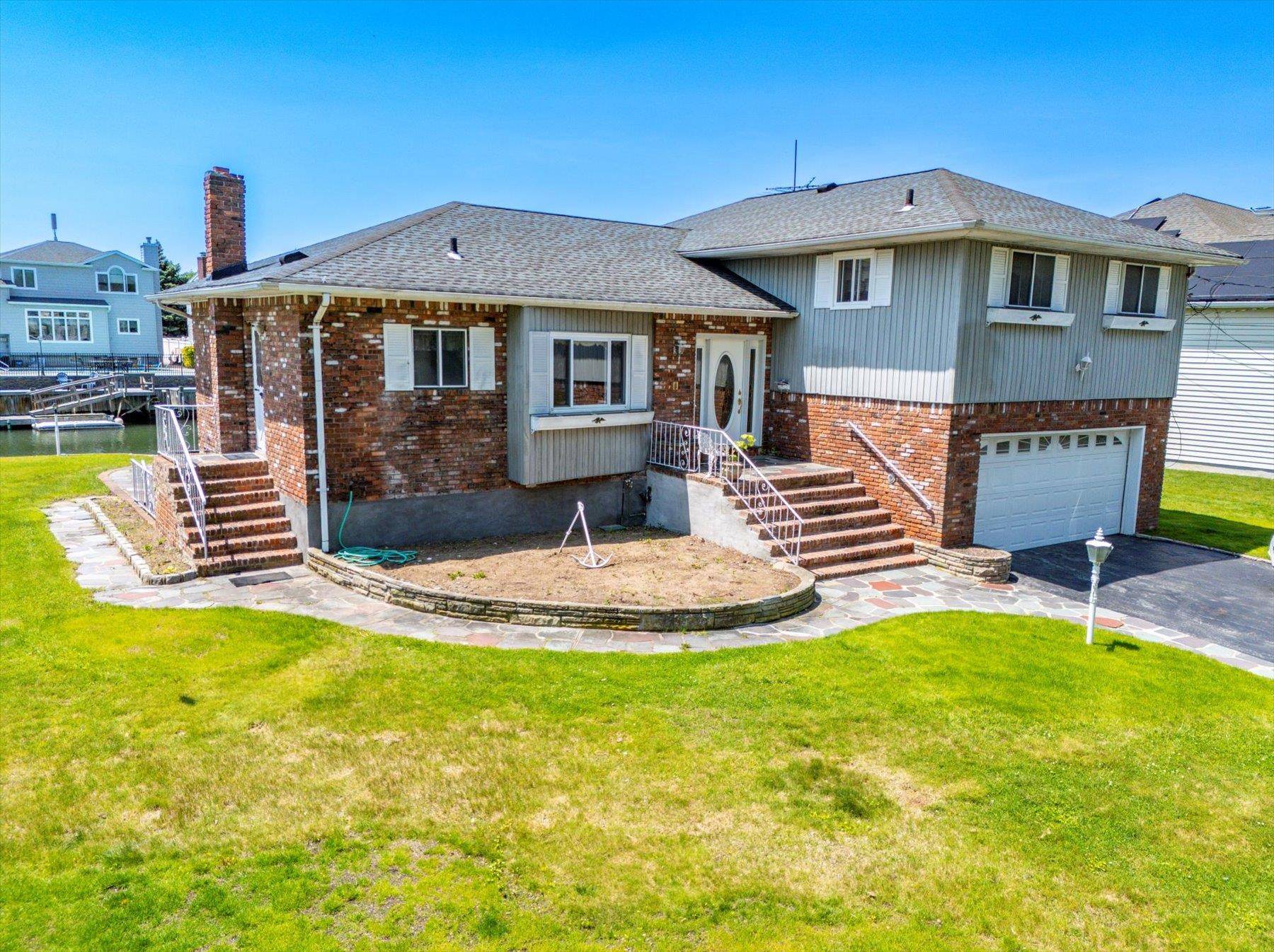 Welcome to your next great investment or dream home opportunity, perfectly positioned on the canals of Old Harbour Green, one of Massapequa's most coveted waterfront communities.