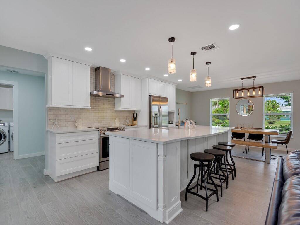 Newly remodeled, comfortable central beach pool home with fenced in back yard and heated pool.