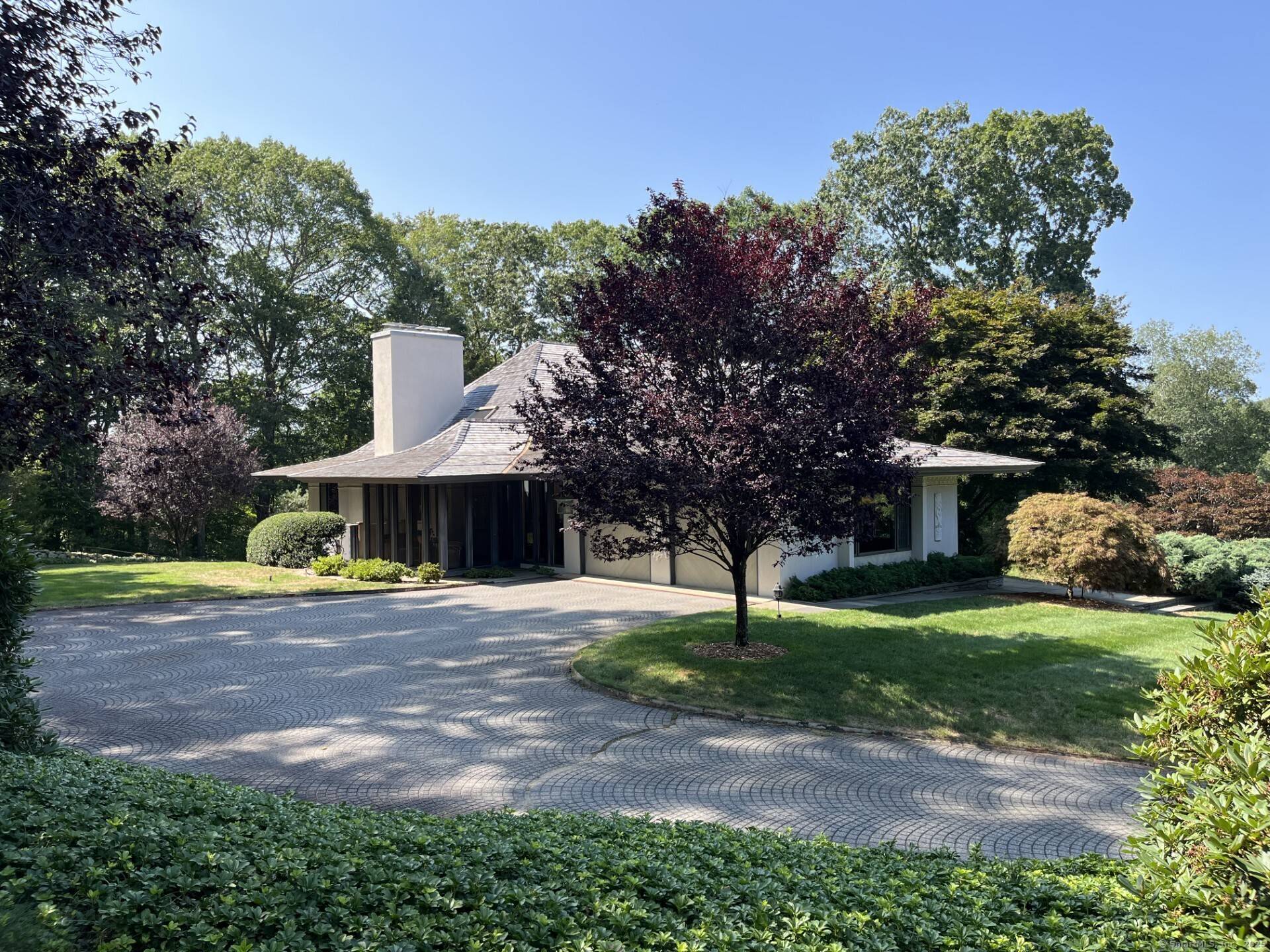 This custom masterpiece, inspired by Frank Lloyd Wright, embodies a refined architectural vision defined by balanced proportions, strong clean lines, soaring ceilings and meticulous attention to detail.