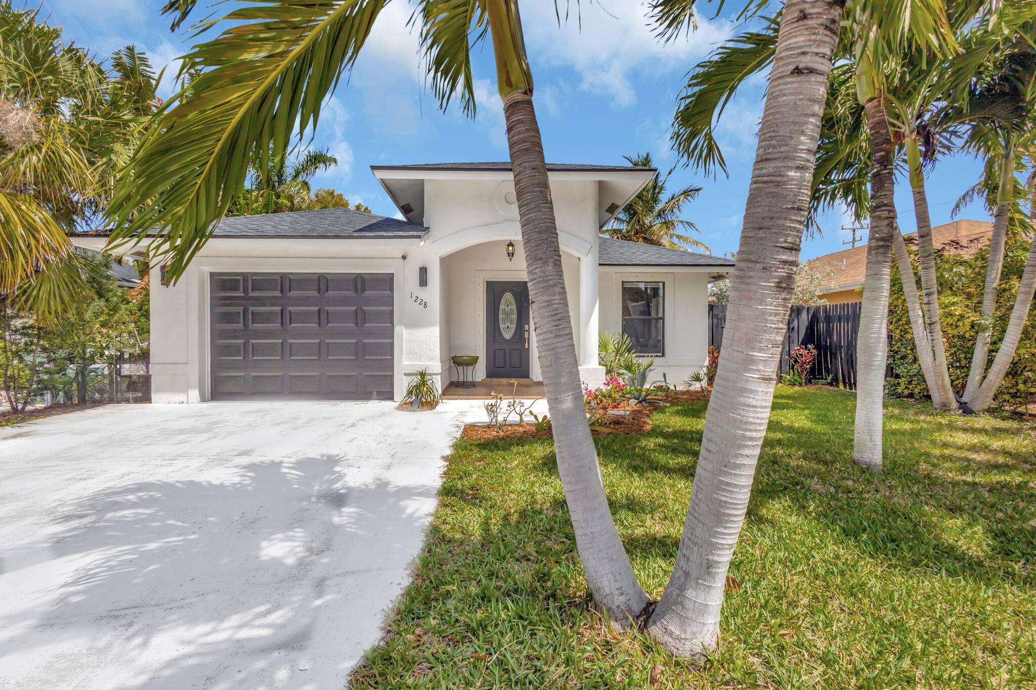 Experience the perfect blend of historic charm and modern luxury in this beautifully renovated 3 bedroom, 2 bathroom residence in Lake Worth Beach.