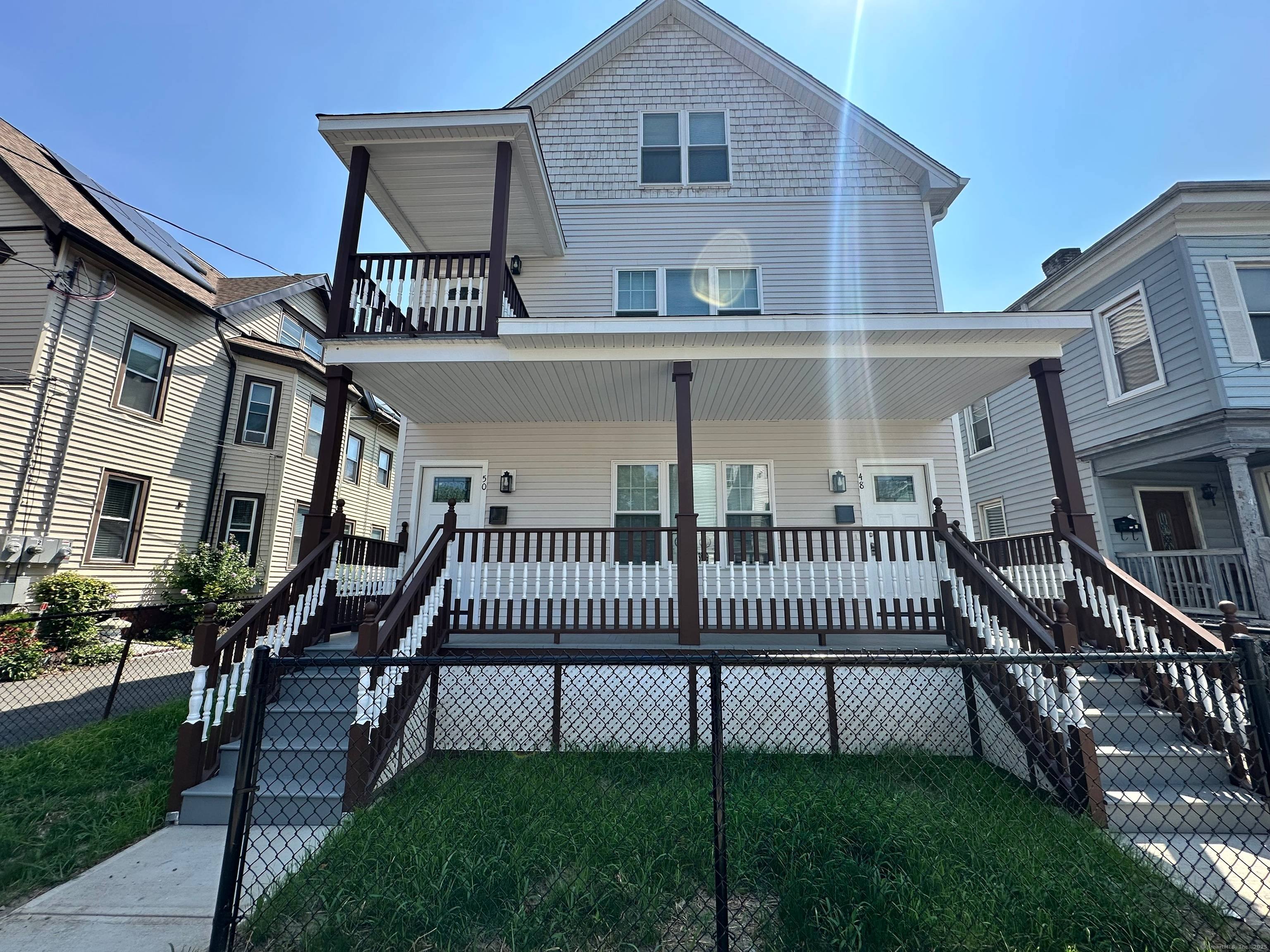 Fall in love with this beautifully redesigned three story two family home in Hartford's vibrant North End, just minutes from downtown.