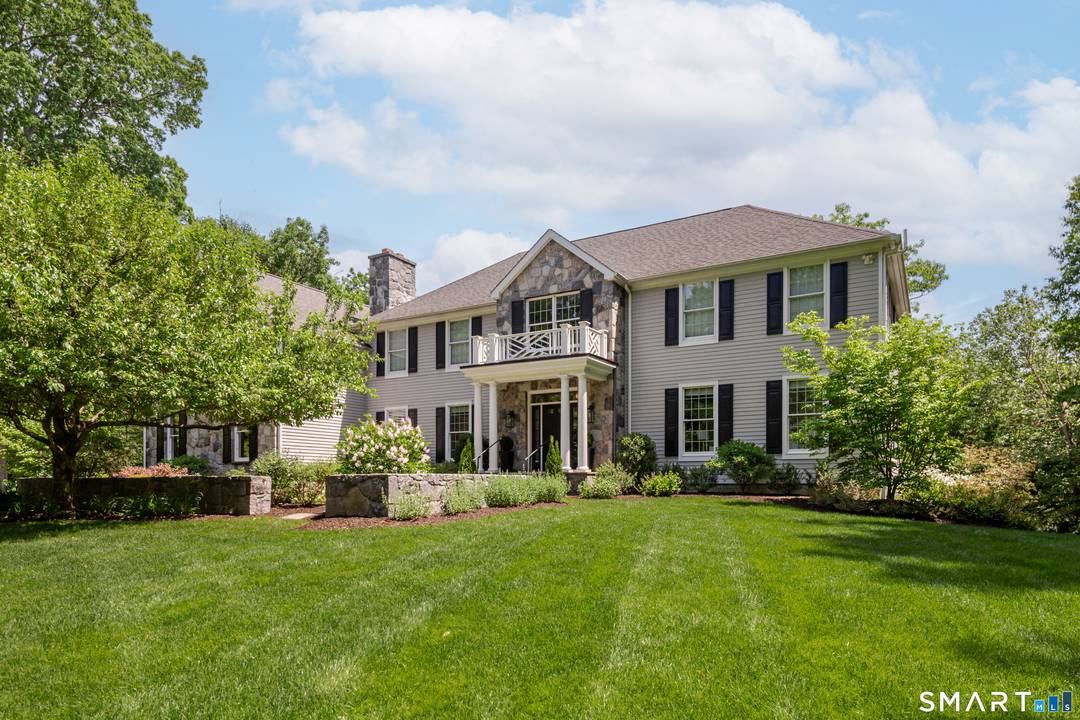 Tucked away on a quiet lane this spectacular sun drenched Colonial offers modern living with a seamless connection to nature.
