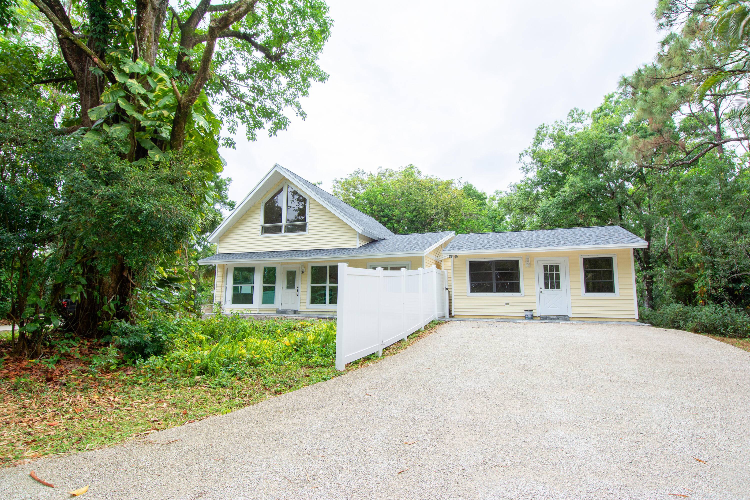 Escape to the serene beauty of Jupiter Farms with this meticulously upgraded property, offering a unique blend of luxurious country living and practical income potential.