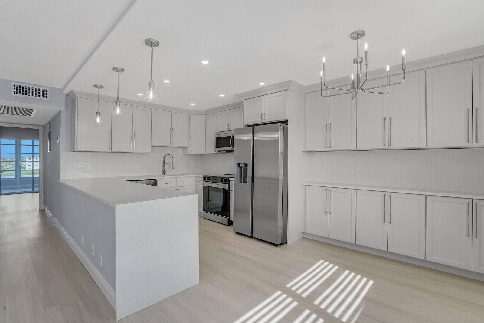 Enjoy incredible lake views from this gorgeously remodeled penthouse unit in the highly sought after Ainslie division of Century Village.