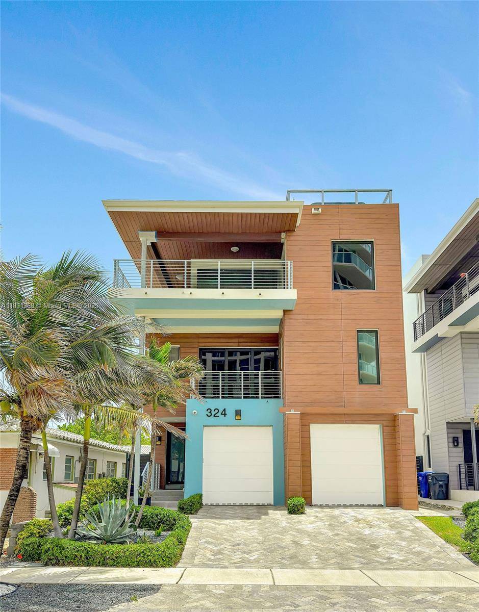 This stunning modern home with 4 bedrooms and 3 1 bathrooms spans three floors and private roof top terrace, offering breathtaking ocean views at just 50 yards from the water.