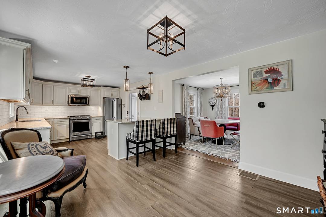Charm abounds in this remodeled classic cape with 2 car garage, central air, and massive 1st floor master suite !